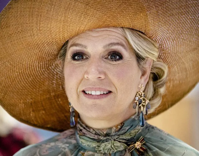 Queen Maxima wore a floral print dress from spring summer 2020 collection of Natan. Gold diamond earrings from Ole Lynggaard