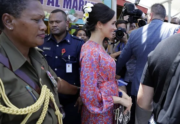 Meghan Markle wore Figue Frederica printed ruffle dress and Castañer Carina Black canvas wedge, and she wore Karen Walker gold stud earrings