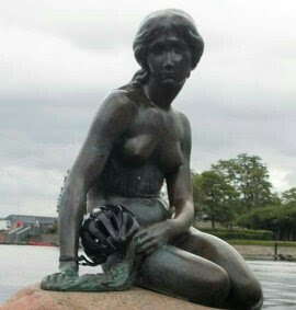 "Little Mermaid" with a "Cycling Helmet" in her hand.