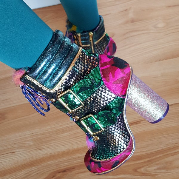 close up of foot wearing pink and green mixed materials ankle boot