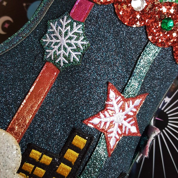 close up of inner side of boot in glitter with embroidered snowflakes