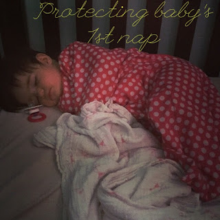 Text: Protecting baby's 1st nap  Picture: baby sleeping in a crib in a red sleep sack with white polka dots