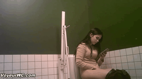 Pissing woman spied in a toilet by hidden camera