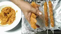 Placing mince chicken on a Shewer in cylindrical shape, two seekh kabab and mince Chicken on side