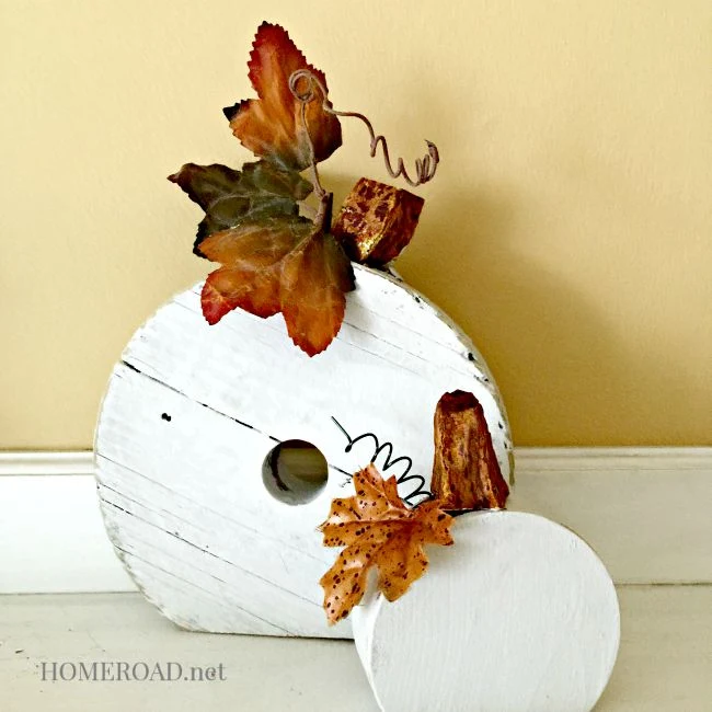 White pumpkins made from repurposed wooden wheels