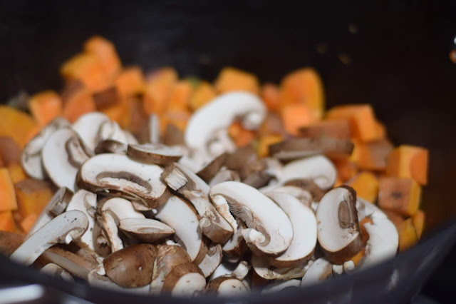 The sliced mushrooms being added to the pot. 