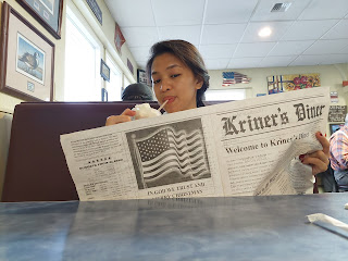 Kim from the Philippines reading newspaper in Anchorage Alaska