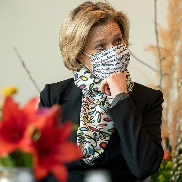 Princess Delphine of Belgium wore a black belted blazer and silk satin print scarf from Saxe-Coburg. Professor Tessa Kerre is president of the fund