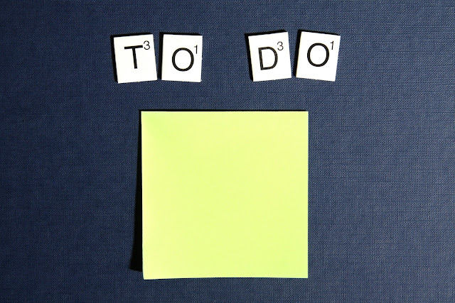 A yellow Post-It note with the words "TO DO" spelled out on top.
