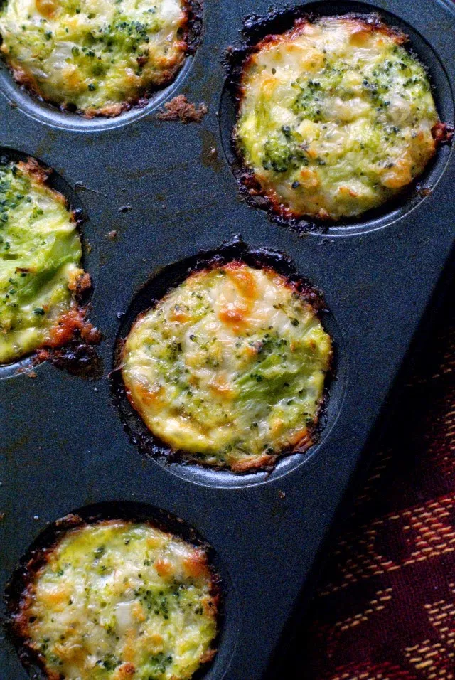 Baked Broccoli Tots in a metal muffin tin.