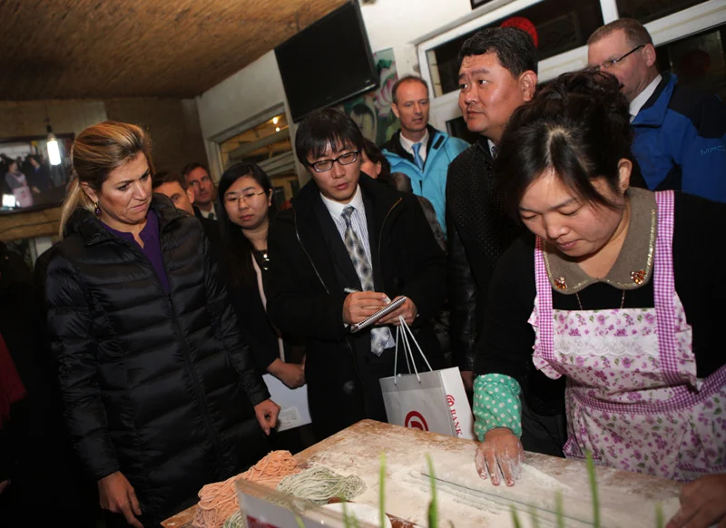 Beijing hotel in Daxing district staff demonstrating the art of handmade noodle making as well as business 