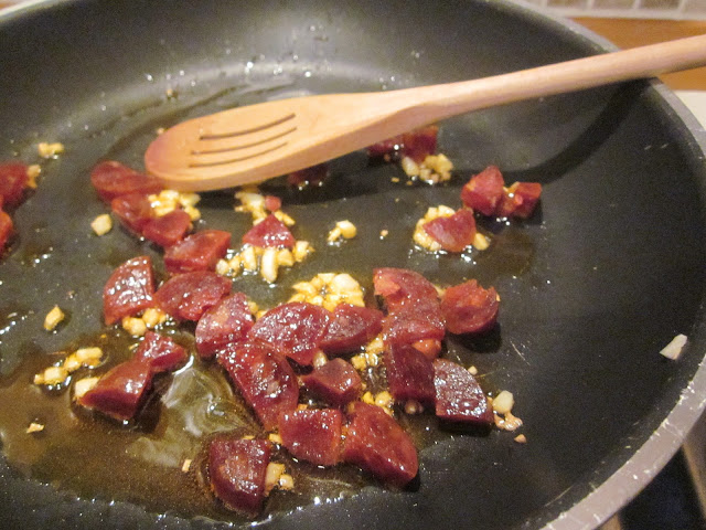 chorizo frying in a pan