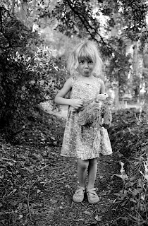 Portrait en pied de Mila (ma fille) en costume avec son doudou dans la forêt du Coquillon proche de notre potager.