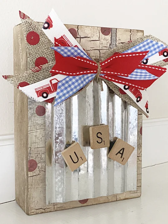 box with magnetic galvanized steel, a bow and USA Scrabble letters