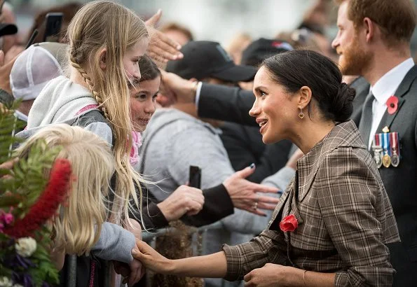 Meghan Markle wore Karen Walker Banks coat, Asos Design Maternity dress, Sarah Flint pumps and Birks Musecitrine and diamond drop earrings