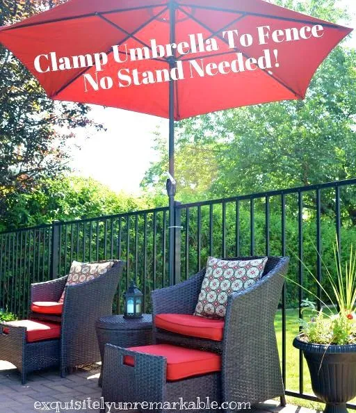 Sitting area around pool with umbrella clamped to fence