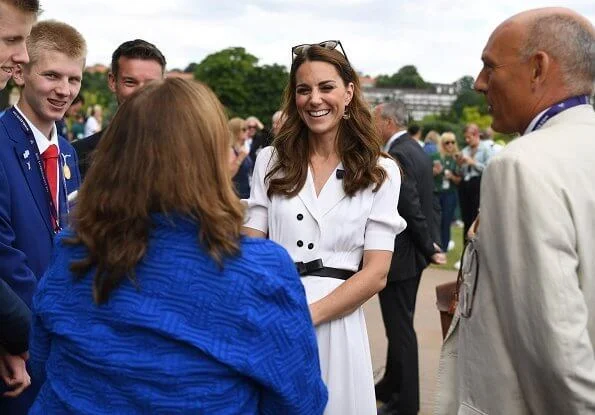 Kate Middleton wore a Suzannah flippy wiggle dress, Alexander McQueen Wicca raffia satchel, Tod's suede pumps