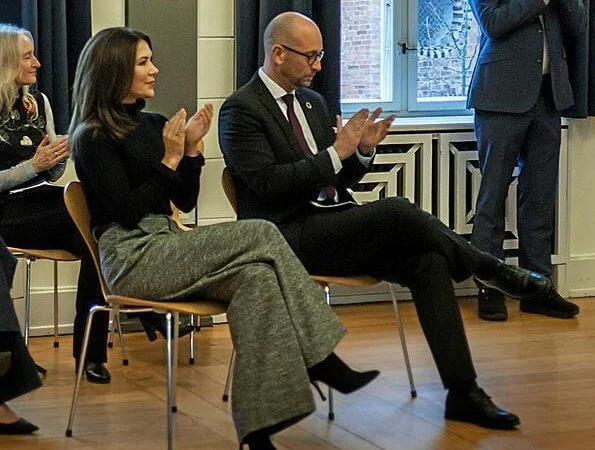 Crown Princess Marie wore a multicolour wool pants from Celine, and ruffled high collar and sleeve black sweater. Gianvito Rossi suede boots