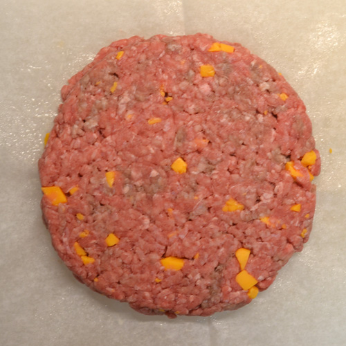 Half-pound burger patty filled with nuggets of mild cheddar