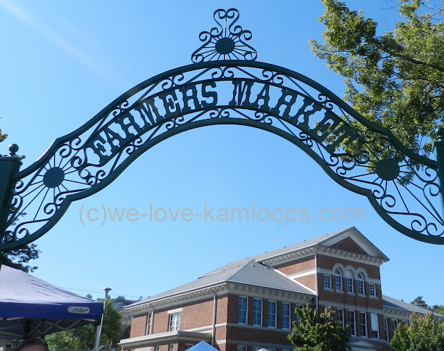 A sign for Farmers Market is over the entrance to the Stuart Wood school