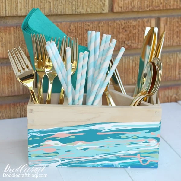 Acrylic Pouring Abstract Painting on Organizer Caddy DIY filled with gold utensils, paper straws and teal napkins