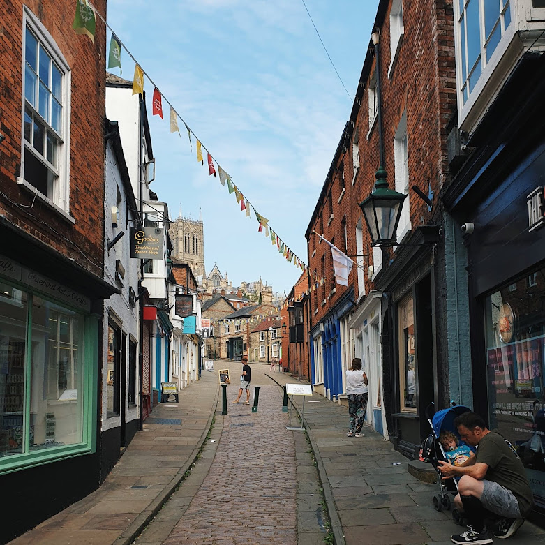 lincoln steep hill, market town, independent shops, flags and bunting, cobbled streets