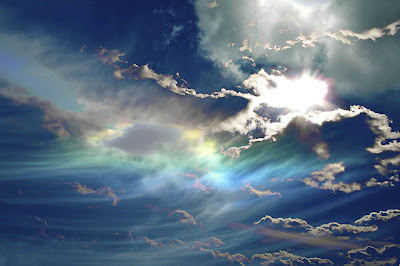 sun through blue clouds