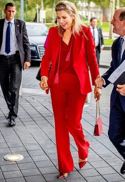 Queen Maxima wore Claes Iversen LaPerm classic blazer and Lykoi trousers and Korat silk blouse. she carries Chanel red bag