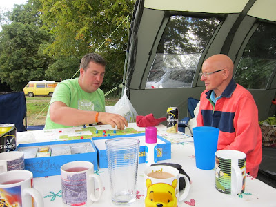 Carcassonne being played amongst the debris of camping