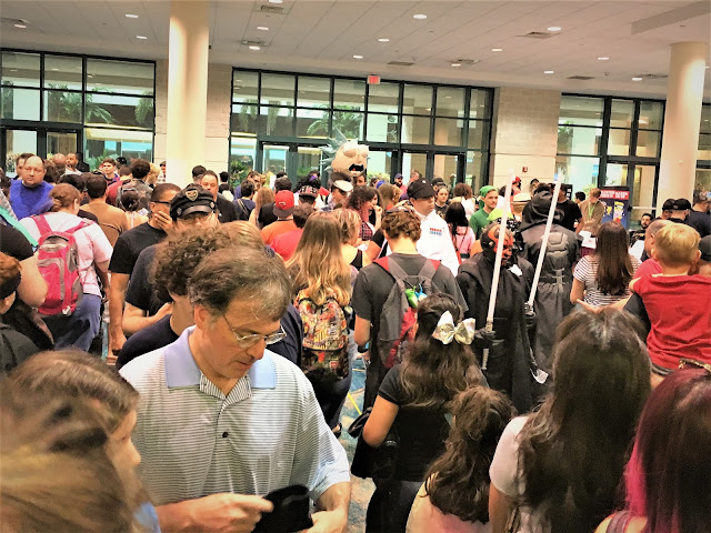 A lot people standing in line to enter Supercon with pre-purchased tickets.