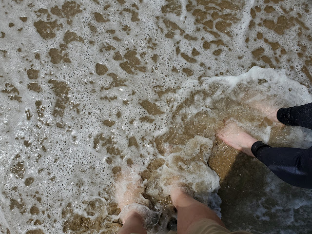 Image of our feet in an ocean wave