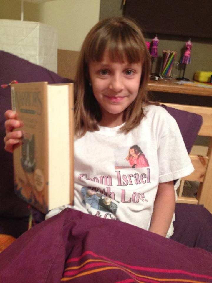 Abby with new shirt and new book