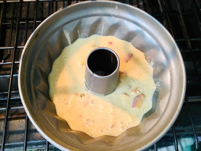 bundt pan with peach cake batter