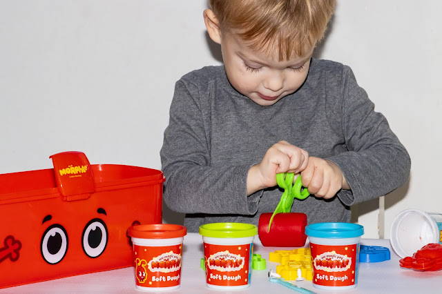 A preschooler playing with the Morphle dough set