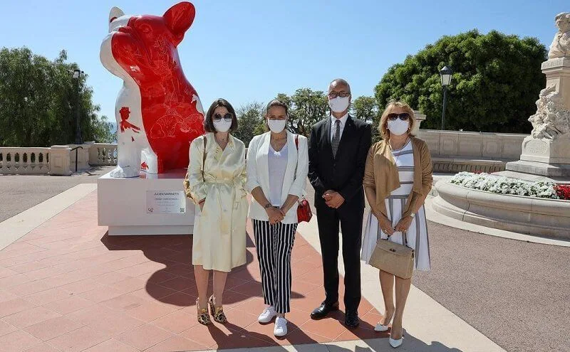 Princess Stephanie, Louis and Marie Ducruet at the inauguration of the sculpture of Doggy John. White jacket, striped pants, red bag