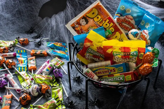 Swizzels Monster Treats sweets some of which have spooky wrappings like the orange and purple lollies which have pumpkins on and some sweets from the retro hamper
