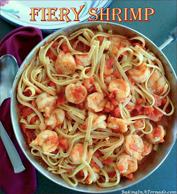 Fiery Shrimp, pan sautéed, steeped in a spicy tomato sauce and tossed with fettuccine. How hot will you go? | Recipe developed by www.BakingInATornado.com | #recipe #dinner