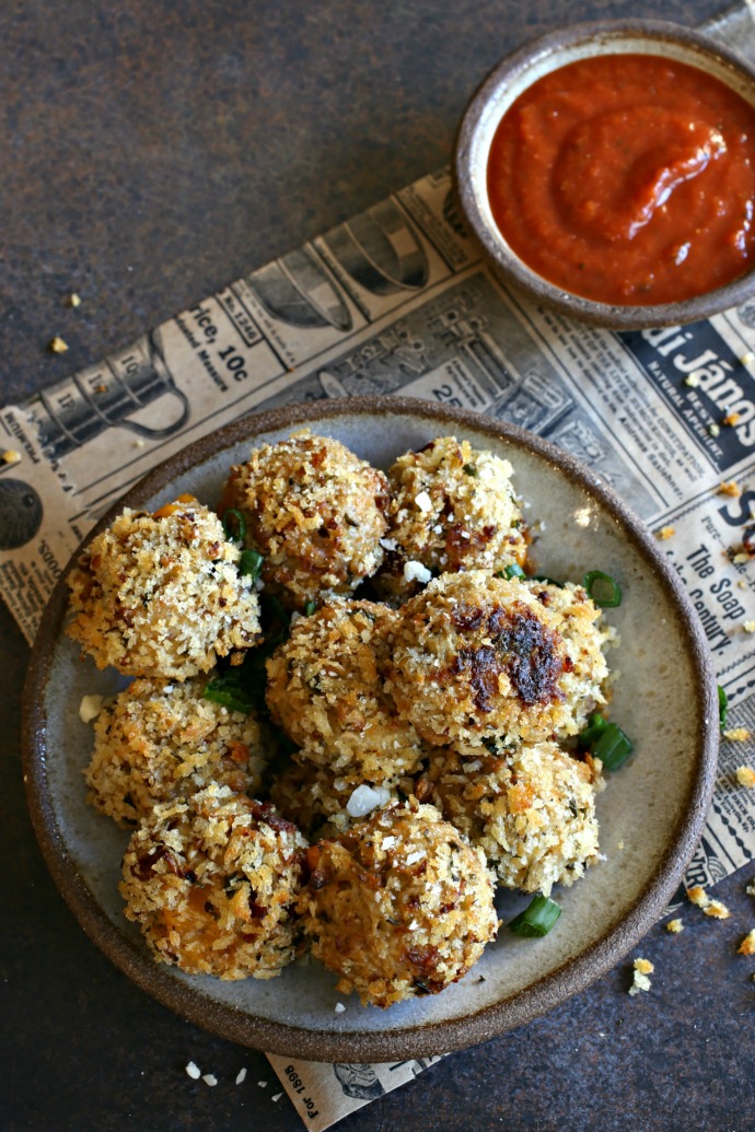 Recipe for baked rice balls made with cauliflower rice, bacon and a cheesy cheddar center.