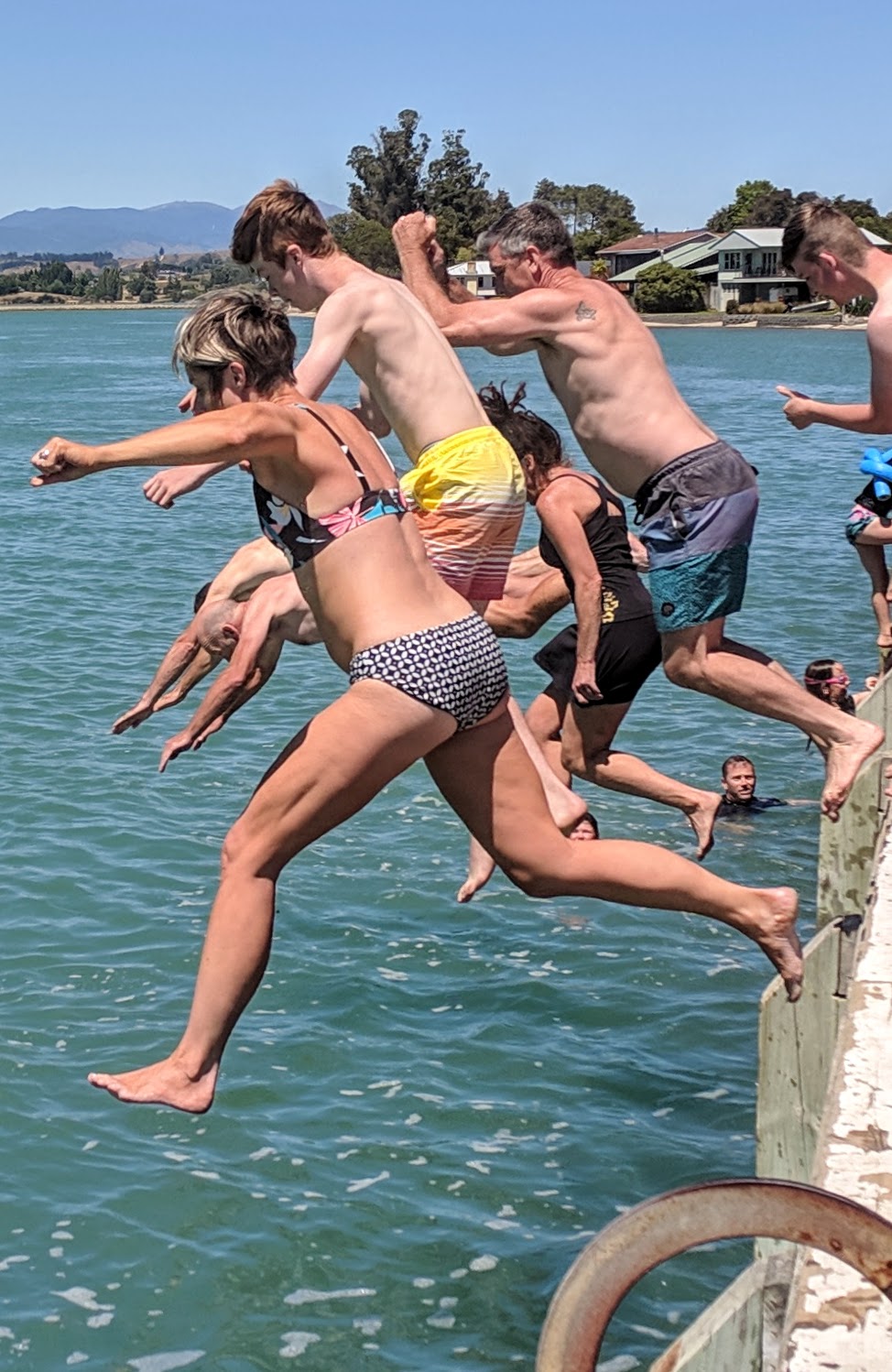 People leaping off the wharf