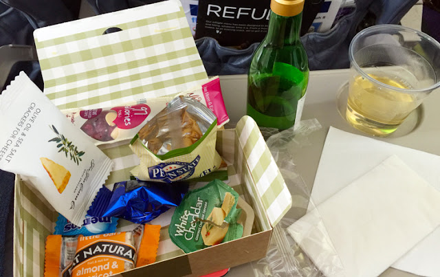 a box with food and a bottle of wine