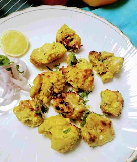 Serving chicken reshmi kabab with onion sliced and lemon wedges