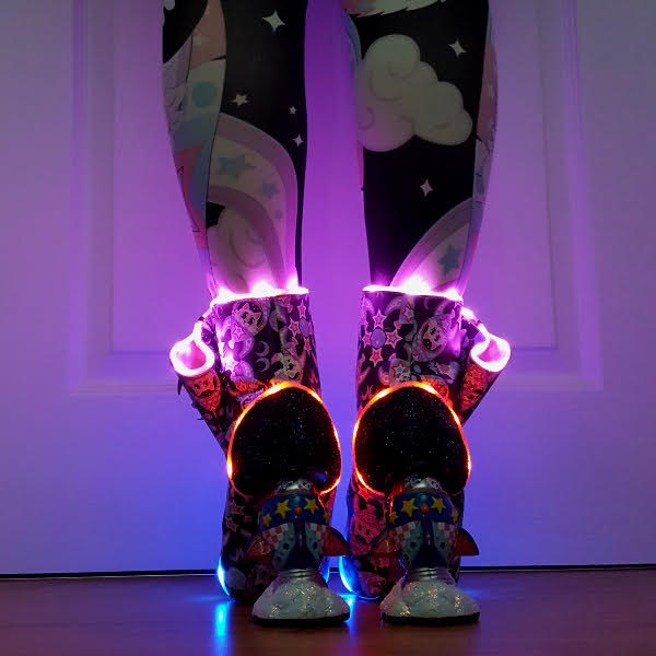 wearing rocket heeled boots with LED lights in the dark