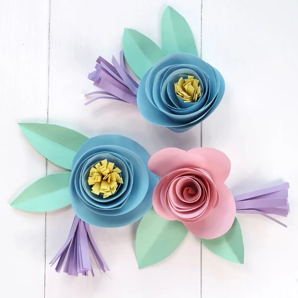 Make a rolled paper flower banner for Spring with pastel cardstock and Tombow adhesive. 