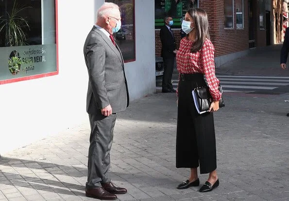 Queen Letizia wore a red houndstooth blouse from Carolina Herrera, and wide leg crop trousers from Hugo Boss