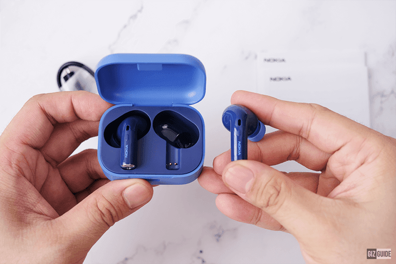 The earbuds have a glossy finish with aluminum stem tips