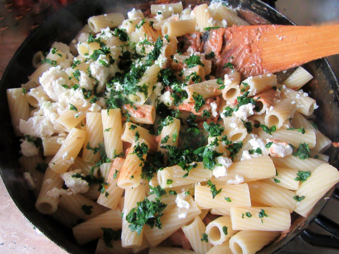 Pasta with shrimp in tomato cream by Laka kuharica: add the cooked and drained pasta with feta, parsley, and basil.