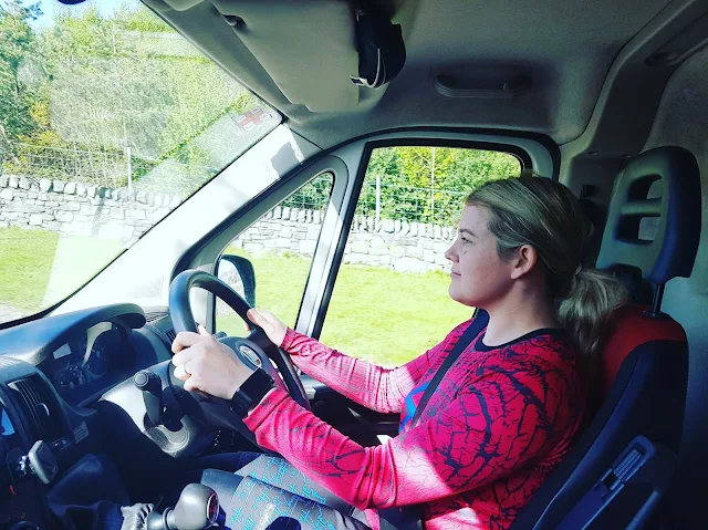 woman in pink top driving big van 