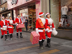 more people dressed up as Santa