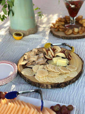 Crackers and cheese on wood slabs for outdoor garden party