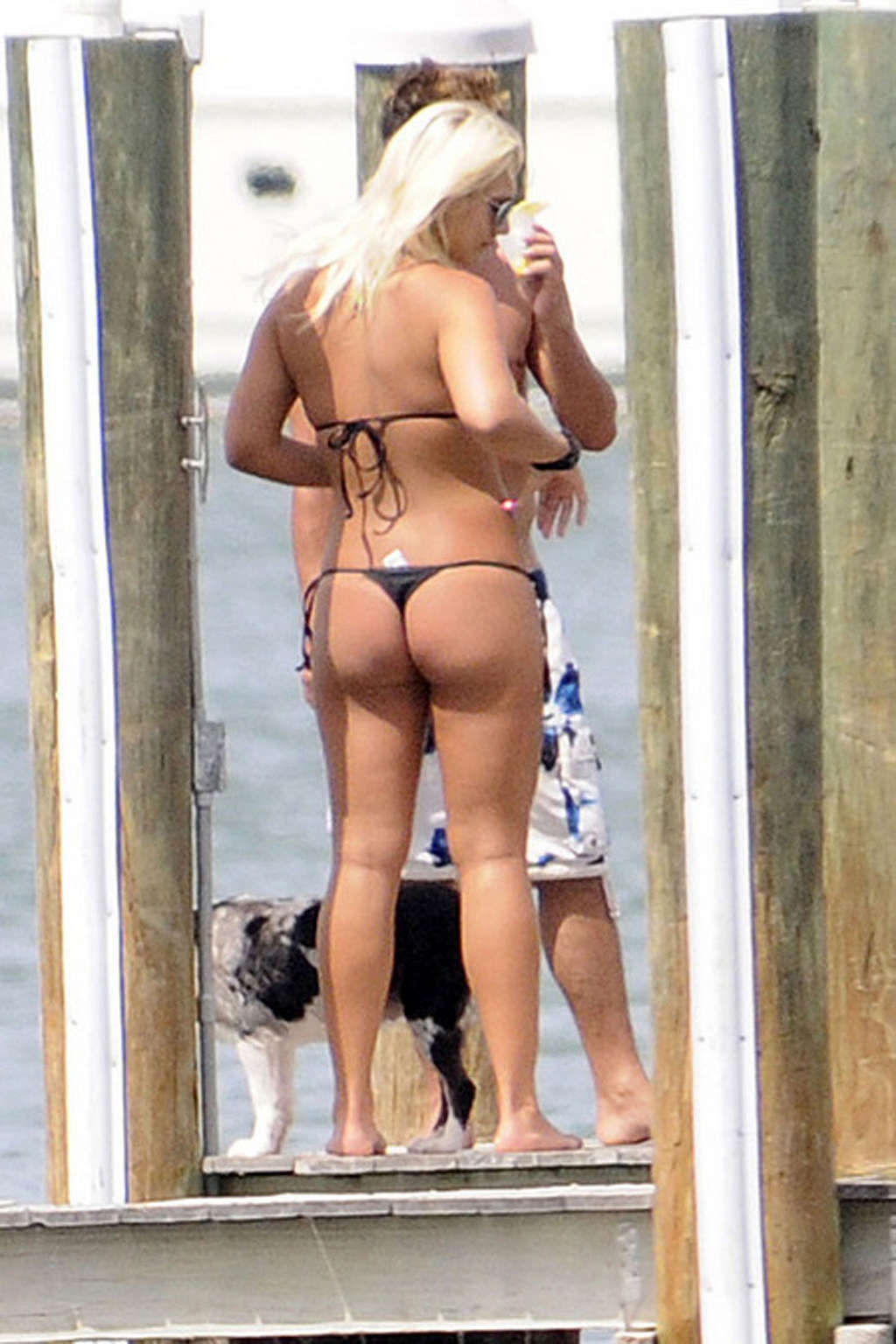 Brooke Hogan walking with most her ass on display in a thong bikini.
